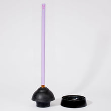 Load image into Gallery viewer, Image of a purple handle plunger with black rubber base set outdie of its black holding base on a white background.
