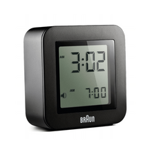 Load image into Gallery viewer, 3/4 view of black digital clock against a white background. The clock face is an LCD screen and can be backlit.
