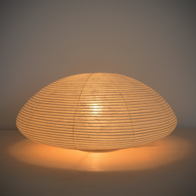 An illuminated simple LED low dome-shaped paper lantern.