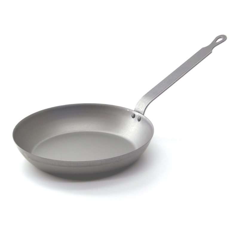Angled view of a low frying pan made of iron with a metal handle.