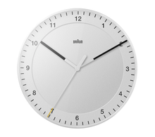 Load image into Gallery viewer, Front view of round white clock on white background. The clock face is white and has white hour and minute hands with black tips. The seconds hand is white with a yellow tip. The hours are shown as black numbers.
