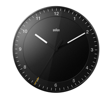 Load image into Gallery viewer, Front view of round black clock on white background. The clock face is black and has black hour and minute hands with white tips. The seconds hand is black with a yellow tip. The hours are shown as white numbers.
