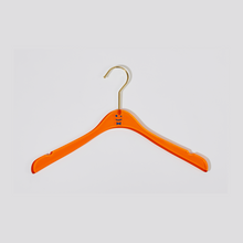 Load image into Gallery viewer, Straight on view of an orange acrylic hanger with a blue smiley face and bowtie in the middle and a gold hook.
